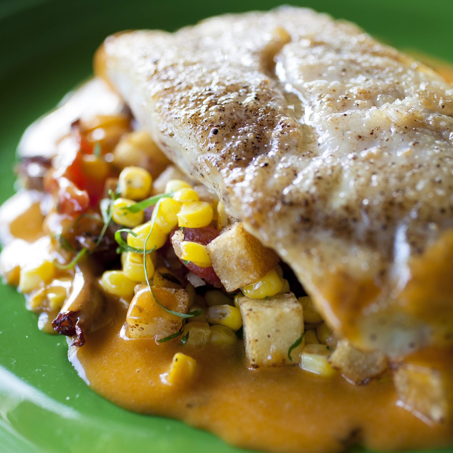Sautéed Redfish with Chanterelles, Creole Tomato Confit, Corn, Brabants,  and Spicy Beurre Blanc
