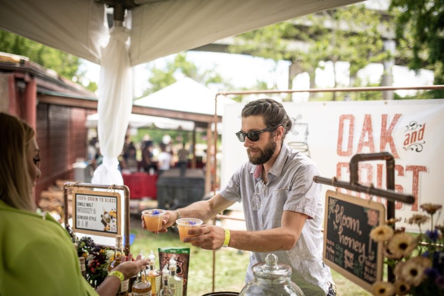 Photograph of a man giving others drinks at Chow Chow: an Asheville culinary festival