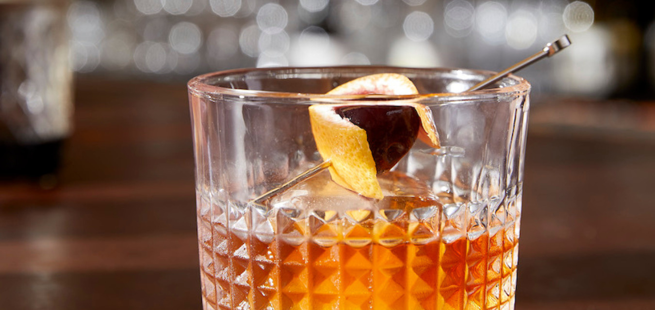 Berry's Classic Old Fashioned, garnished with a brandied cherry and orange peel