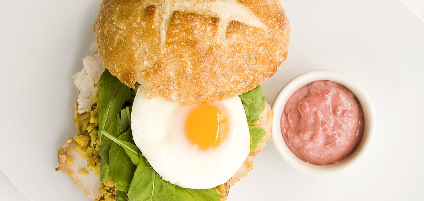 Breakfast sandwich plated beside a condiment cup of Cranberry Aioli, one of our most popular november recipes.