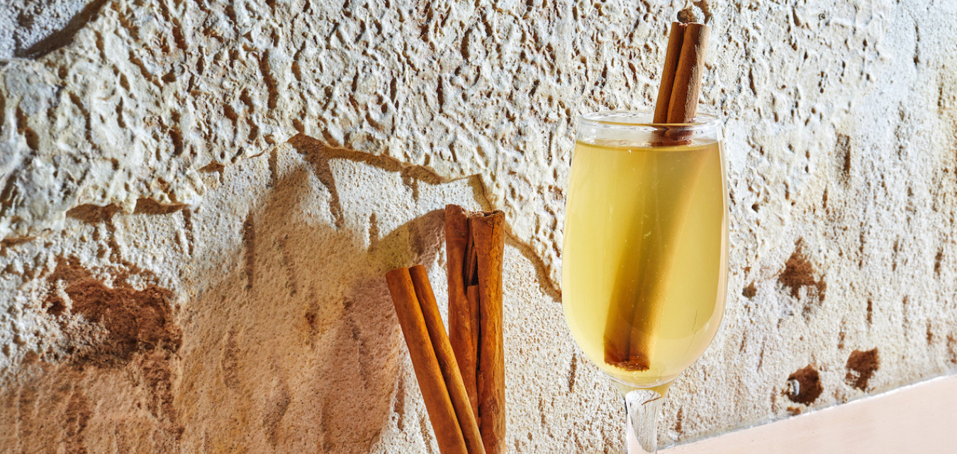 Kimberly Patton-Bragg’s Classic Hot Toddy recipe in a glass garnished with a cinnamon stick