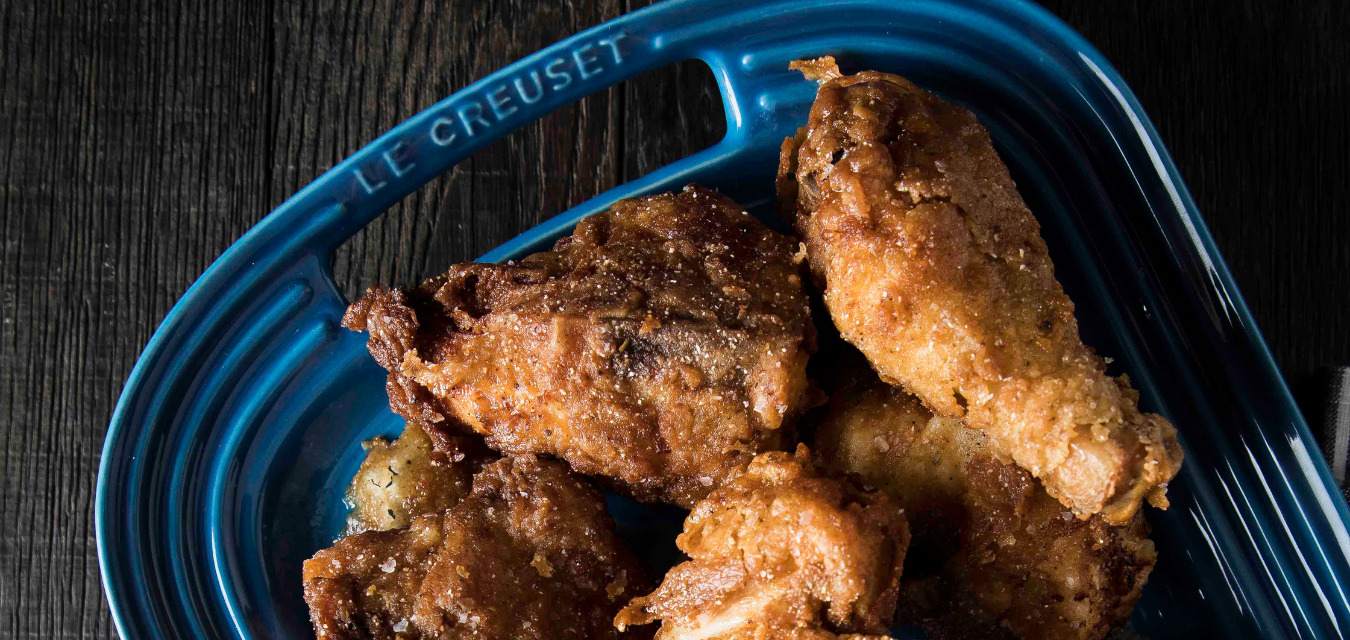 Fried chicken in a blue enamelware serving pan