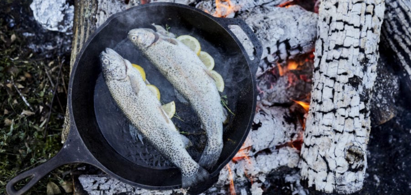 Two Trout in a cast iron pan over the fire