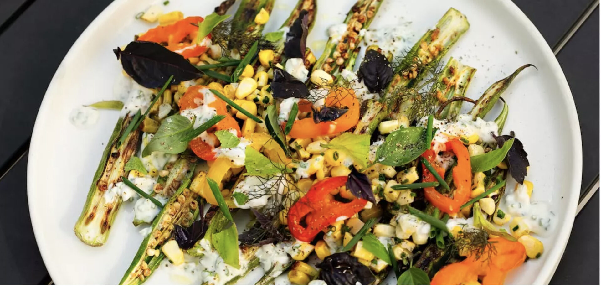 Grilled Okra and Corn with a buttermilk dressing, pickled peppers and fresh herbs, one of six vegetarian dishes in this post