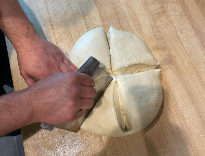 Cutting laffa dough into equal sized pieces