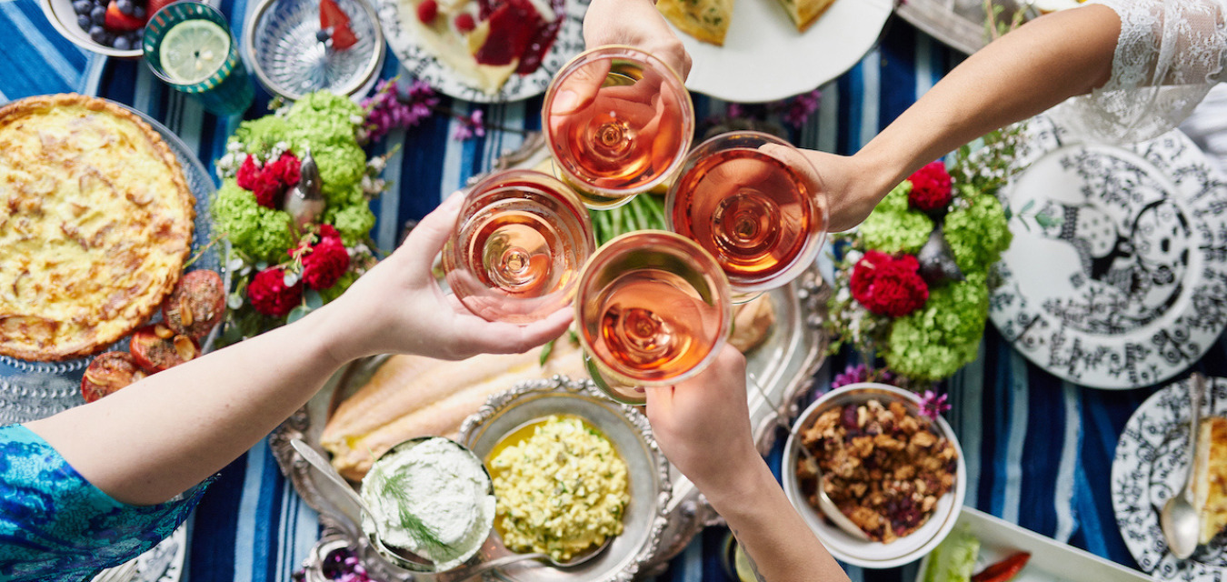 Clinking glasses of rose over Labor Day Tablescape