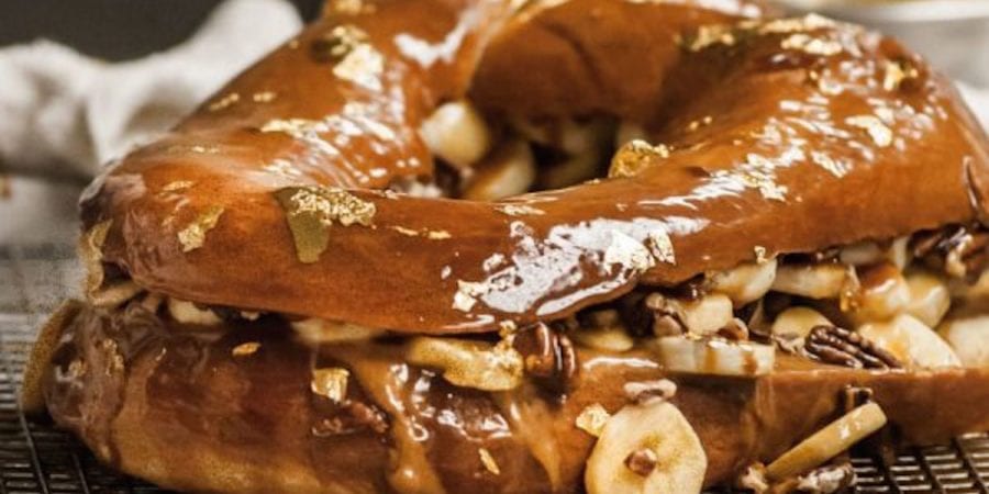 Brioche king cake filled with marscapone, pecans, bananas and topped with caramel sauce