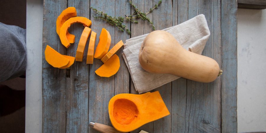Peel and slice butternut squash to use it in fall soup recipes.