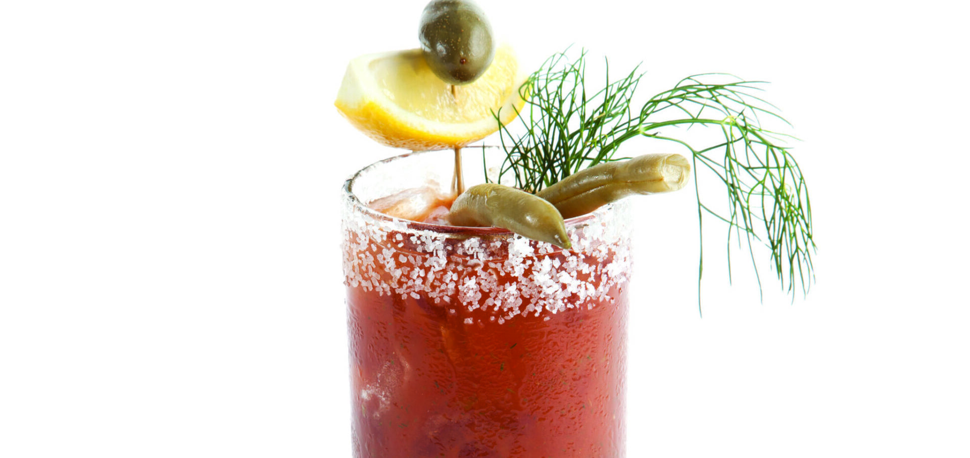 bloody mary garnished with lemon, olives, dill, and cornichons