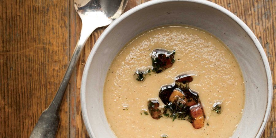 Our fall soup recipes include this roasted parsnip soup topped with crisp pork belly nuggets