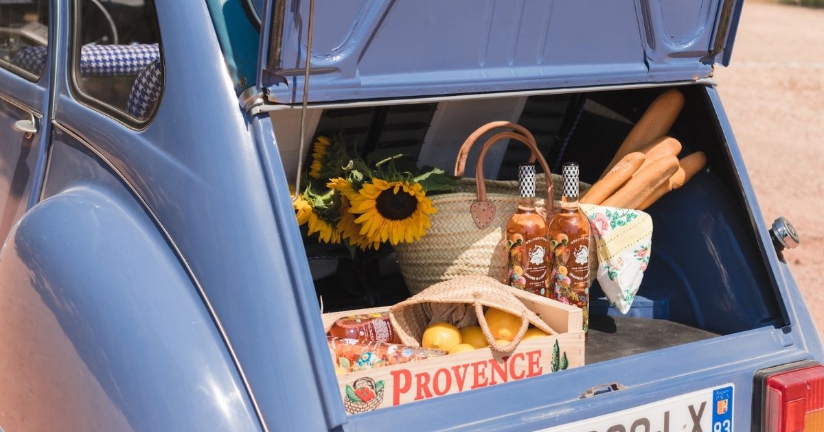 Image of an open car trunk with rosés