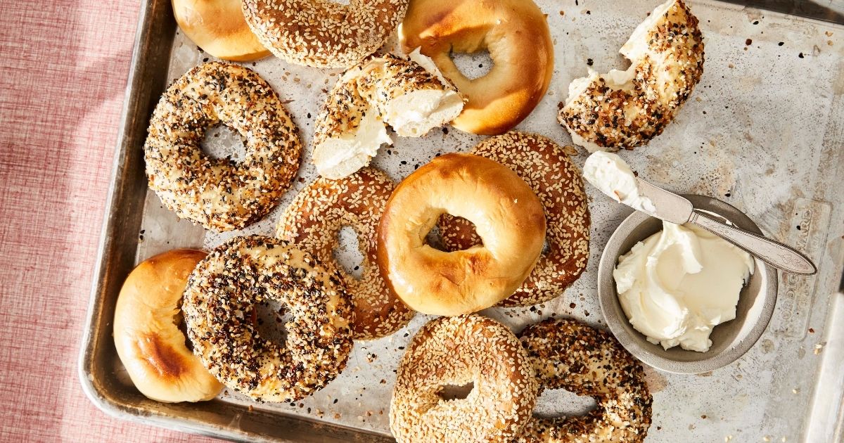 Assortment of Montreal bagels on a pan with schmear
