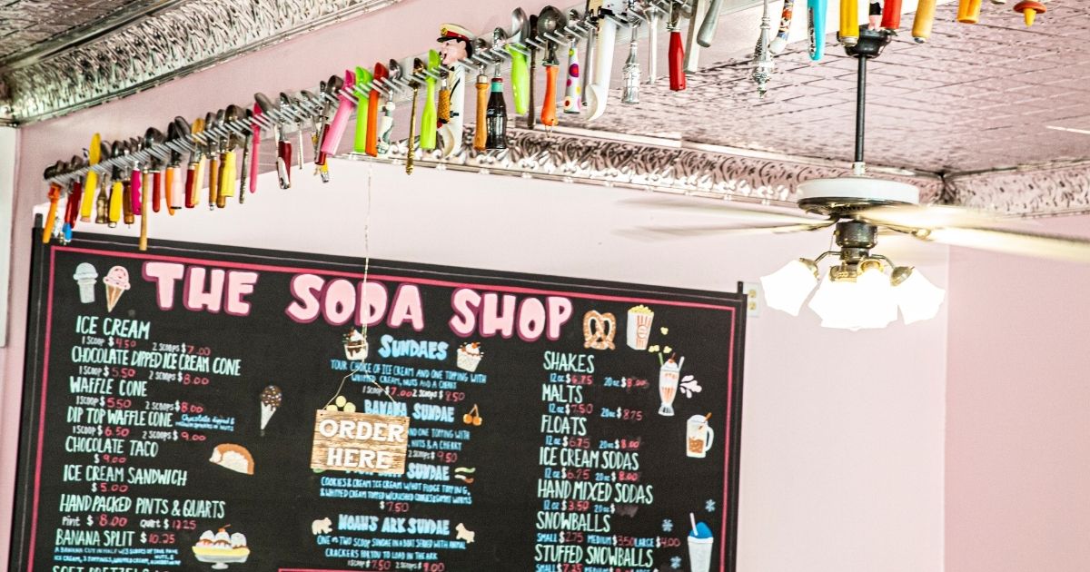 The Soda Shop menu with ice cream scoops hanging from the wall