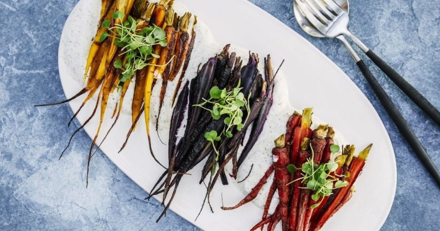 Platter of multi-colored roasted carrots with a sumac yogurt