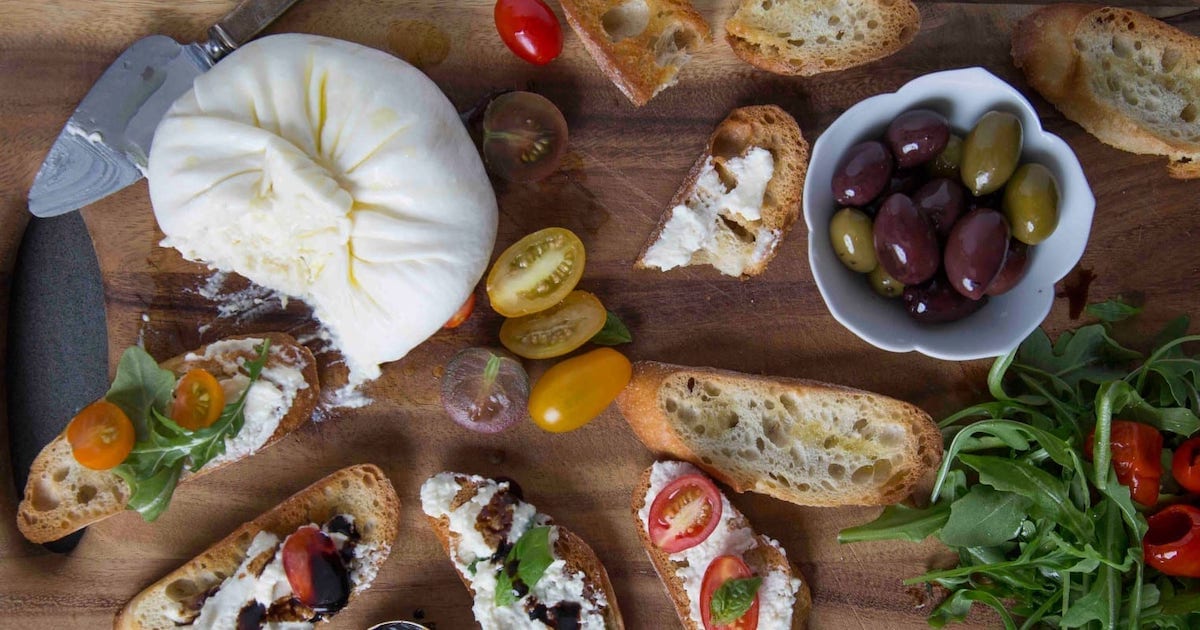 Wheel of burrata surrounded by crostini