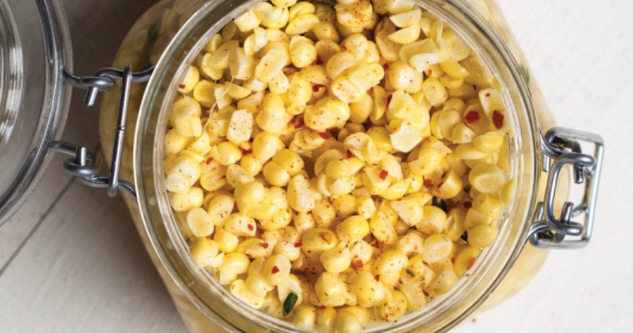 Photograph of corn off the cob in a mason jar, a camping food