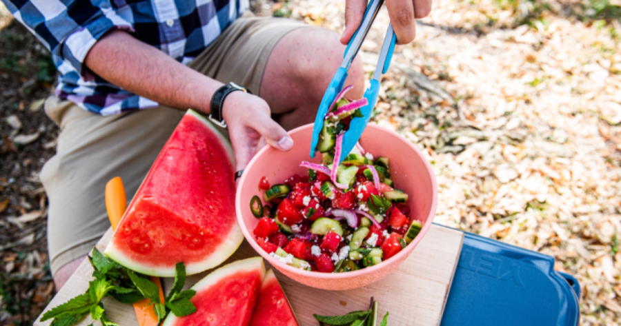 Photograph of spicy watermelon salad being served with tongs, a camping food
