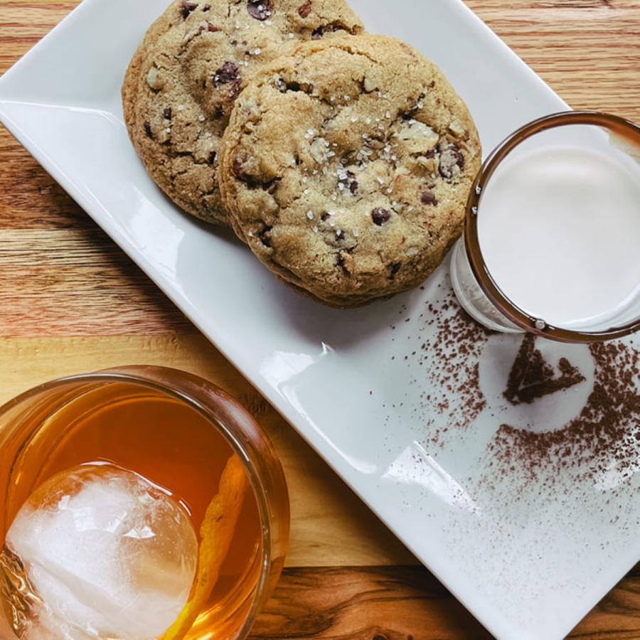 Two chocolate cookies, a mug of milk, and an orange drink from Vance's Bakery Bar, one of the new restaurants in Georgia 