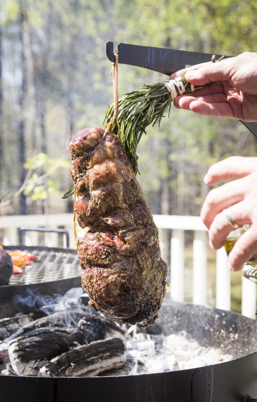 Lamb, a dish from this dinner party menu, being cooked over a grill. 