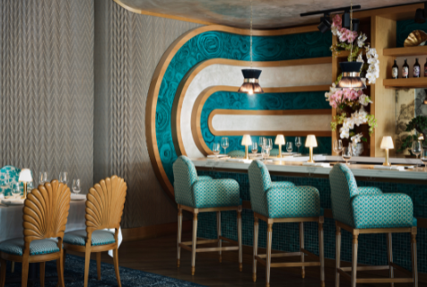 Photograph of the cool, teal bar with barstools at ZZ's Club in Miami