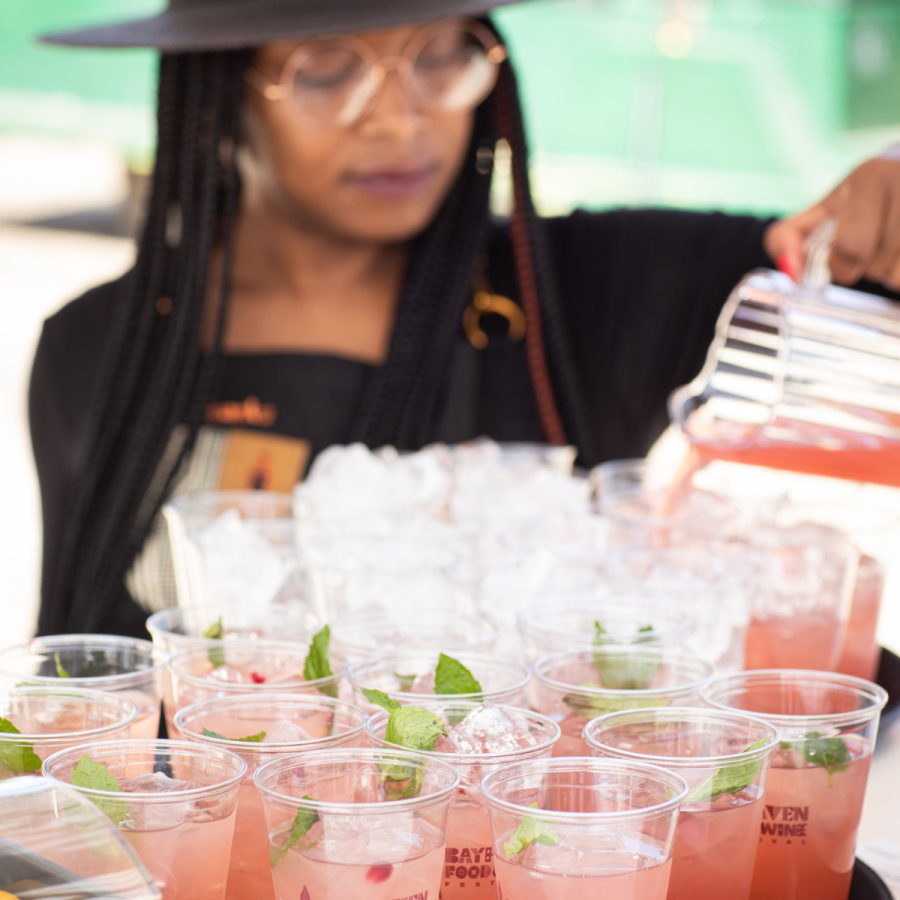 A photo of a person pouring a pink colored drink at BayHaven Food and Wine Festival