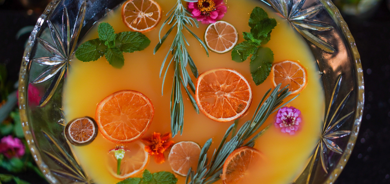 Julep's Brunch Punch in a crystal punch bowlgarnished with sliced oranges, limes, and lemons