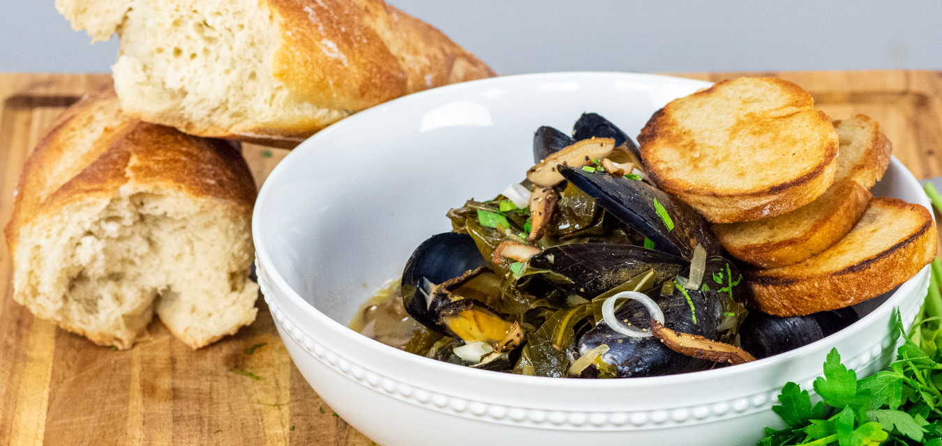 Mussels and Collard Greens served with toasted baguette