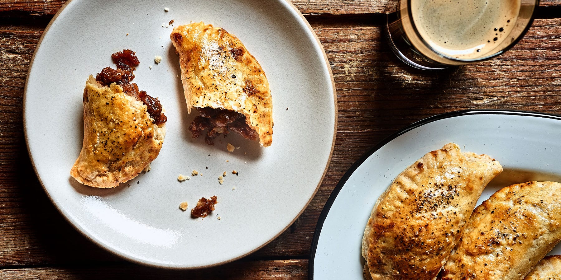 Apple recipes include these peppery apple hand pies, served on a plate with a stout.