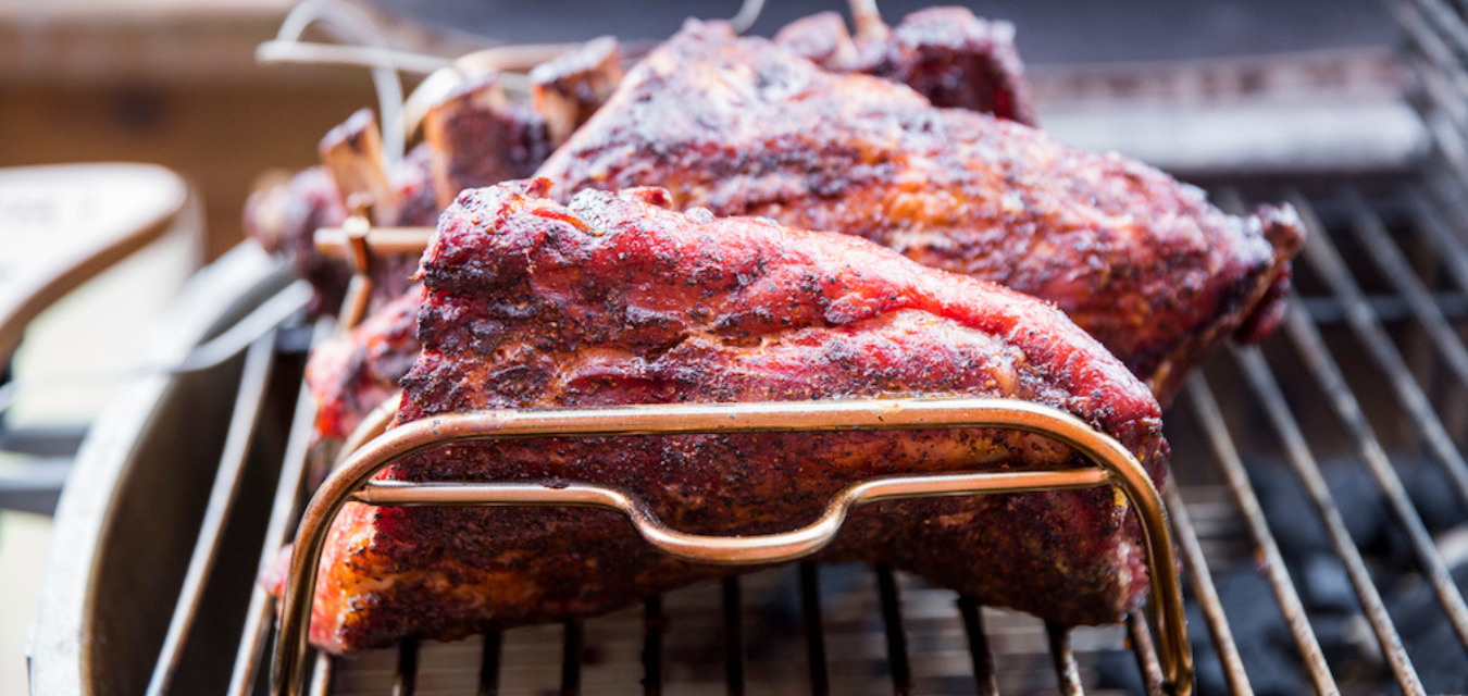 Ribs smoking on a grill, a specialty of Southern pitmasters
