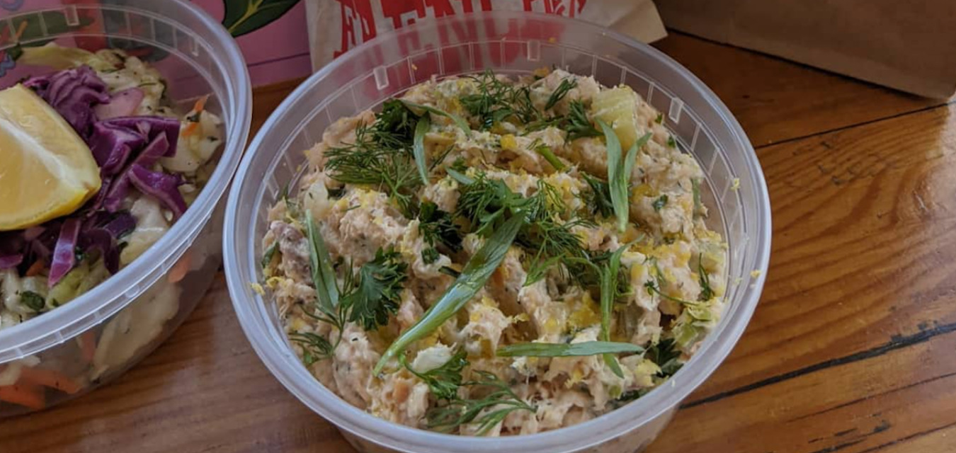 Pint container Ricky Moore's green pimento crab dip, a perfect tailgating recipe.