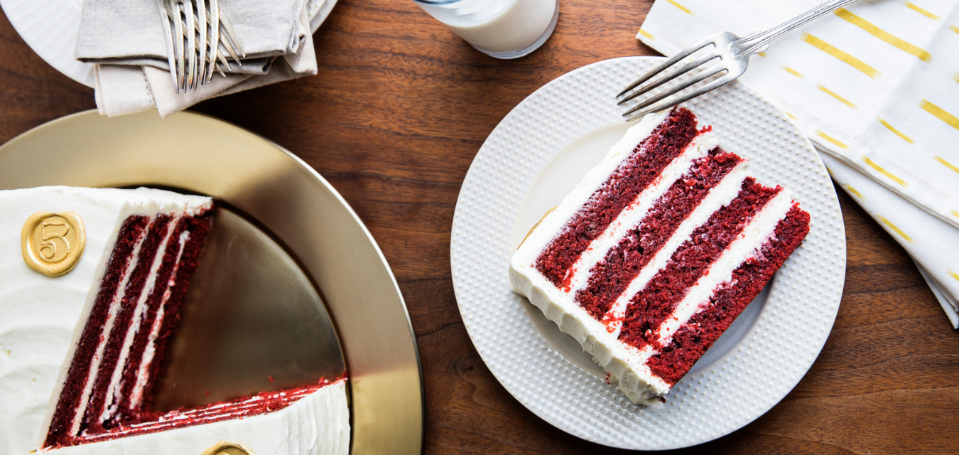 Slice of red velvet cake cut and served on a plate
