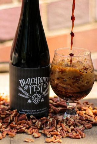 Blacktoberfest Pecan Pie Beer in a bottle and glass.