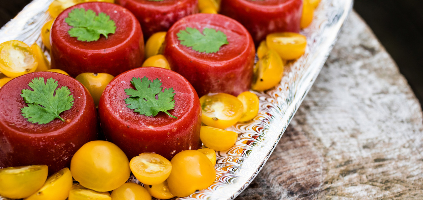 Plated tomato aspic surrounded by sliced cherry tomatoes, one of our most popular November recipes