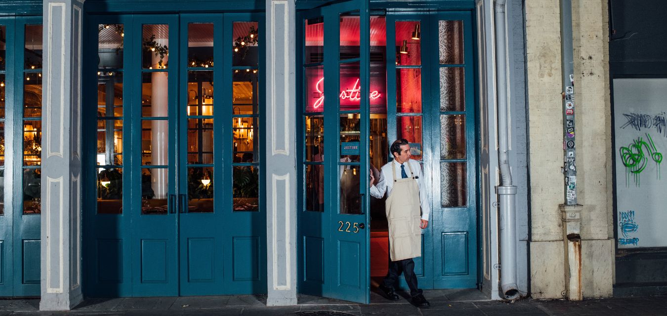 Server opening the door to Justine in New Orleans