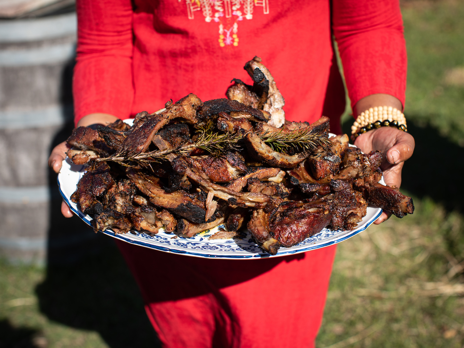 Tia Raiford holding a platter of berbere spiced ribs