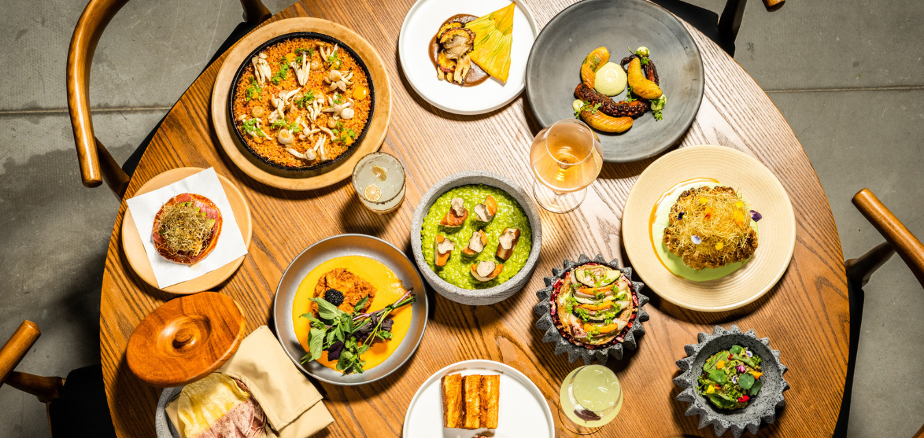 Several plates and drinks on a table at Pablo Santo, one of the new restaurants in the South