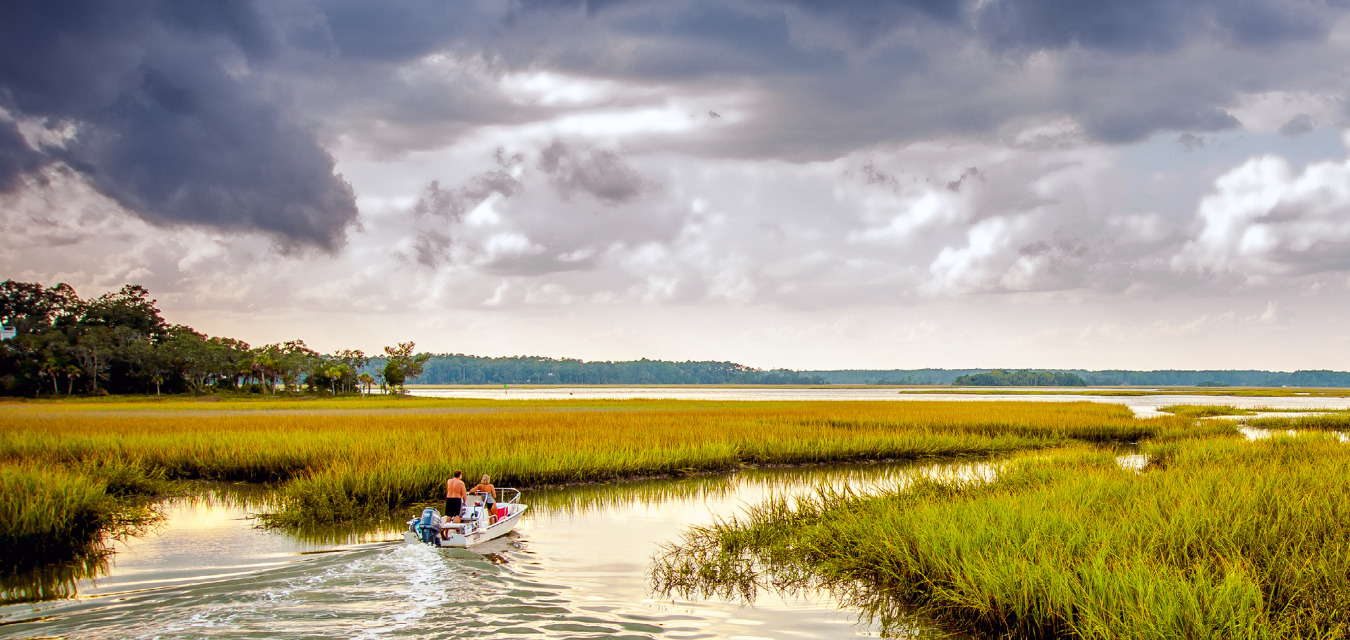 A boat travels along a marshy area in the South Carolina Lowcountry