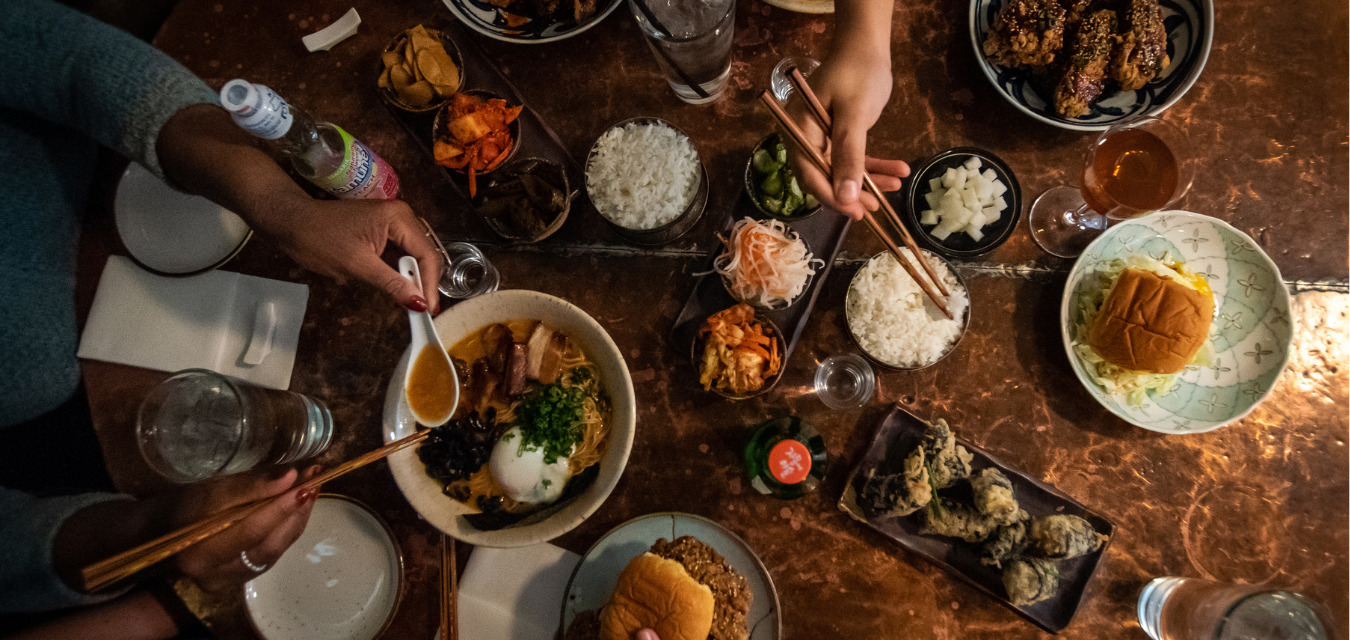 A table of food and people serving themselves at Umma's, one of the new restaurants in Virginia