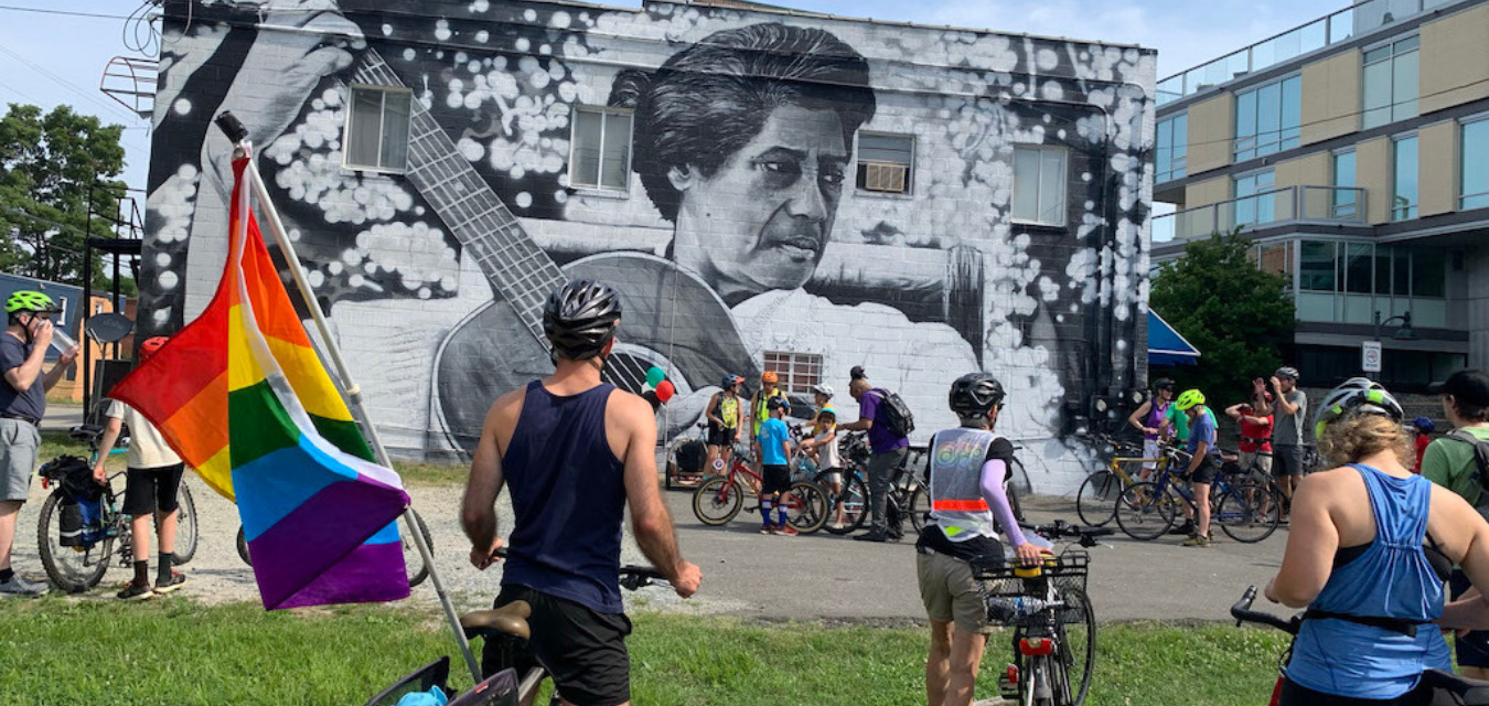 Pride cyclists outside of mural in Chapel Hill, North Carolina