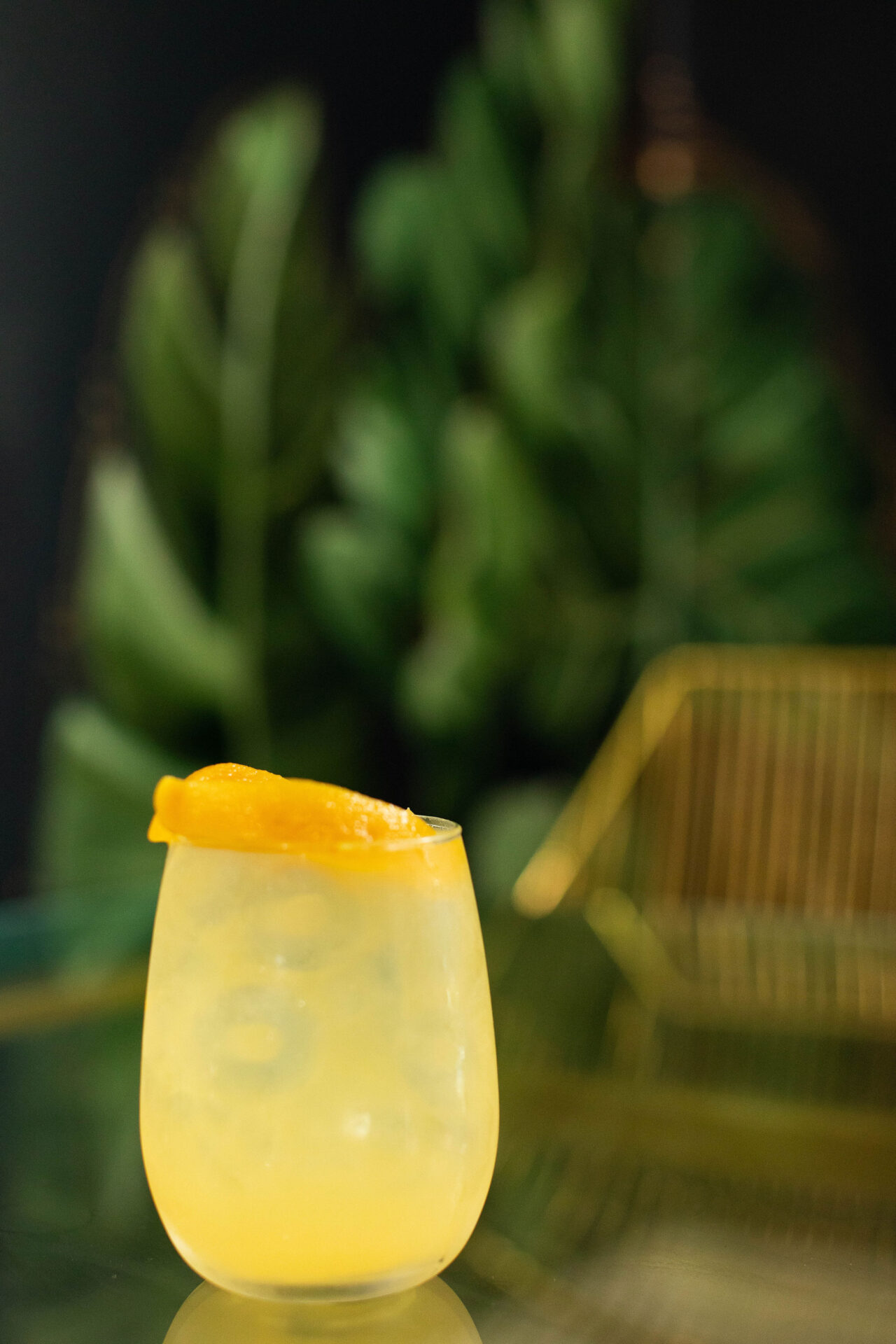 A yellow cocktail with an orange peel at Day Drink Brunch Lounge in Summerville
