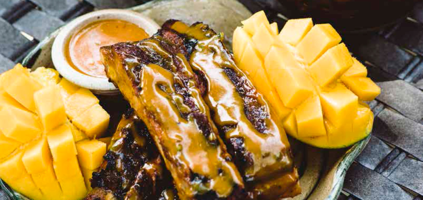 Jerk-spiced spare ribs with mango on the side