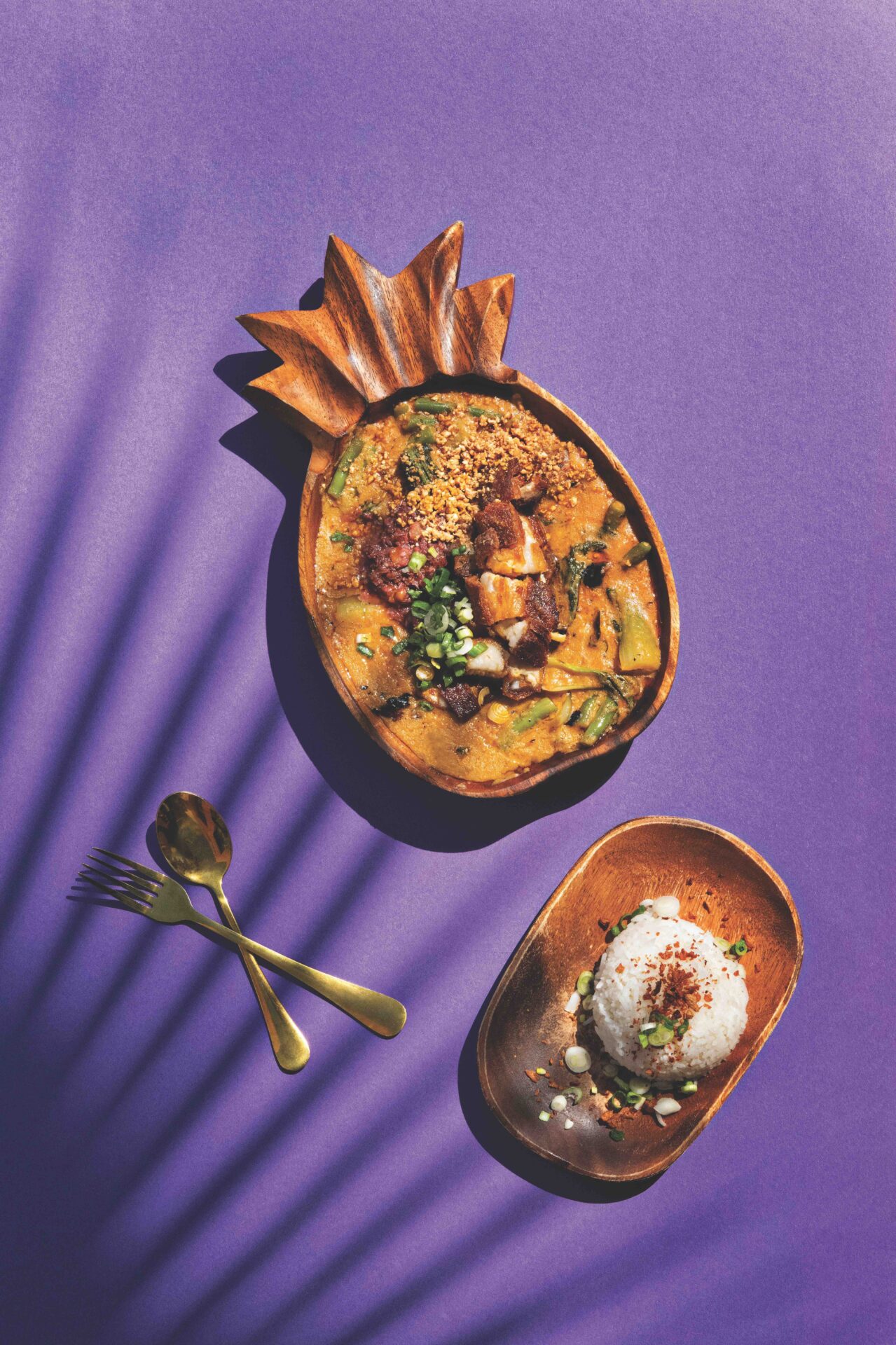 Kare Kare from Purple Roots that serves Filipino food. The Kare Kare is served in a pineapple-shaped wooden bowl with rice
