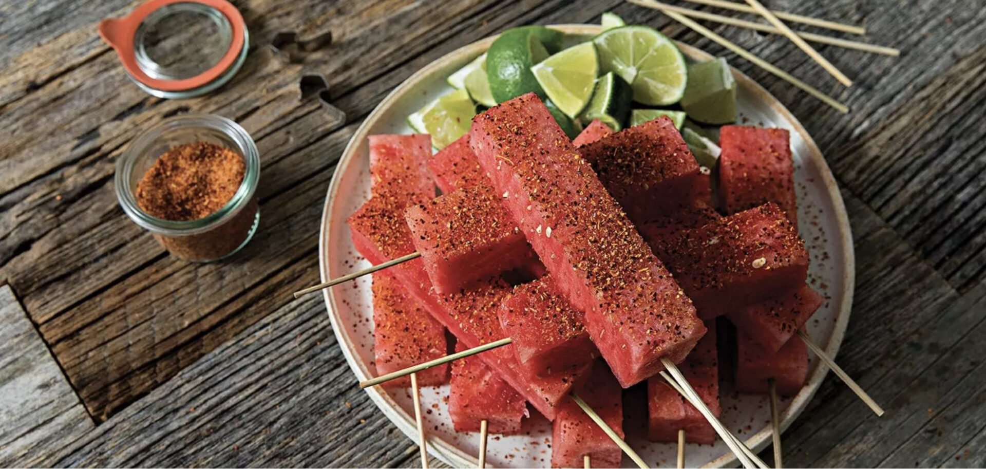 Watermelon skewers and lime wedges on a plate for the Fourth of July