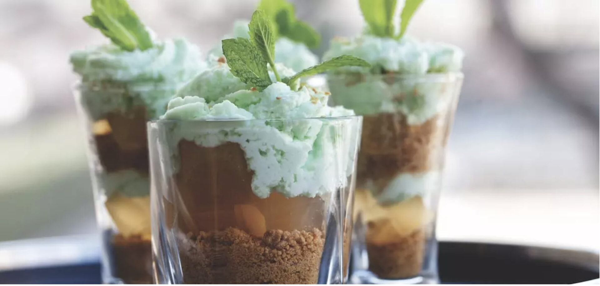 Four mint julep trifles in small glasses topped with mint, one of five no bake dessert options