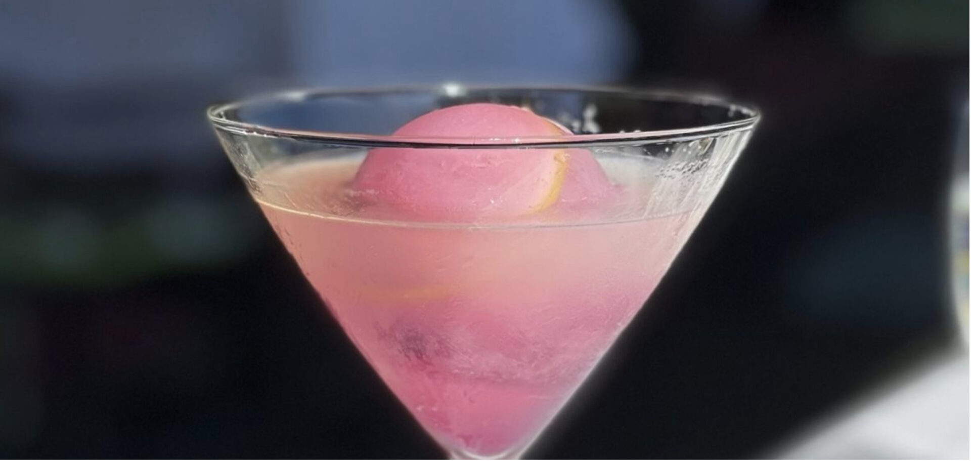 Blueberry Lemontini, a bright pink cocktail with an ice sphere in the middle