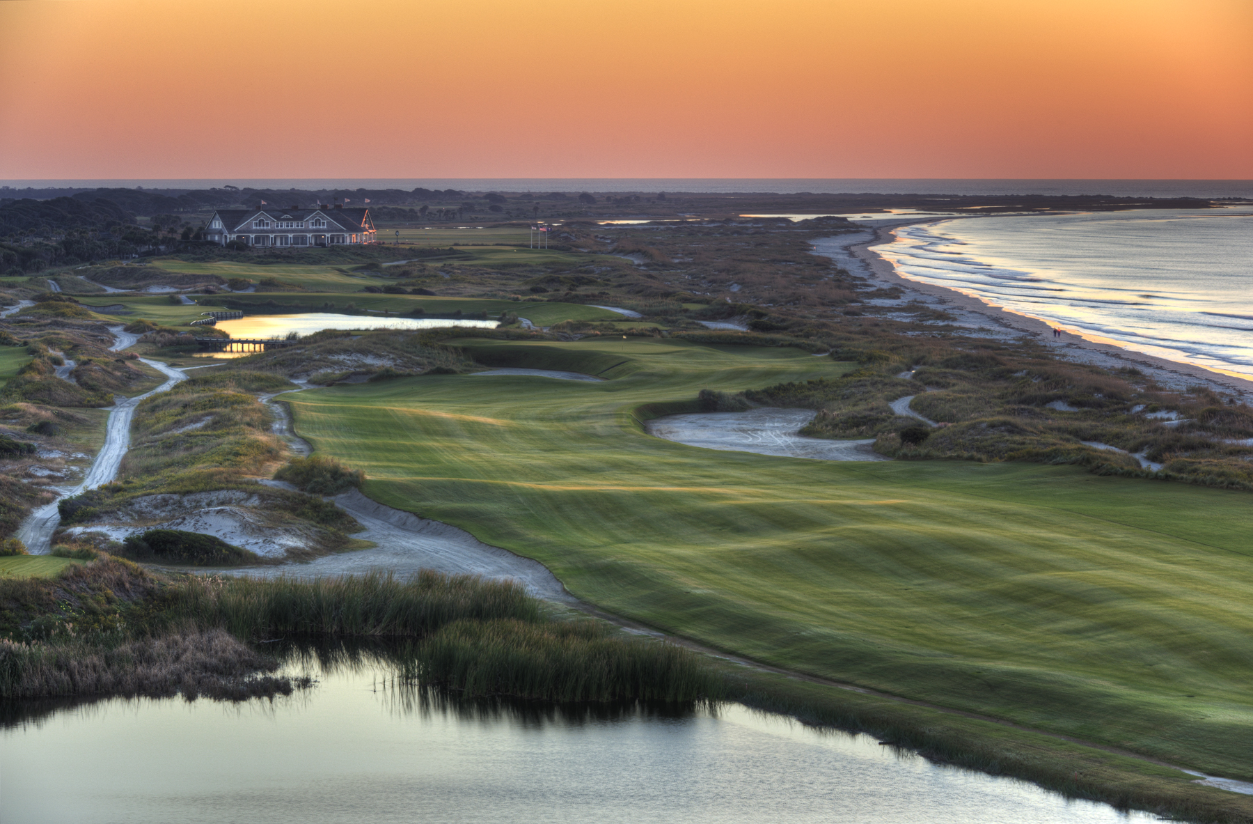 The Ocean Course at Kiawah Island resort part of the sea islands, the sun setting over the water and green. 