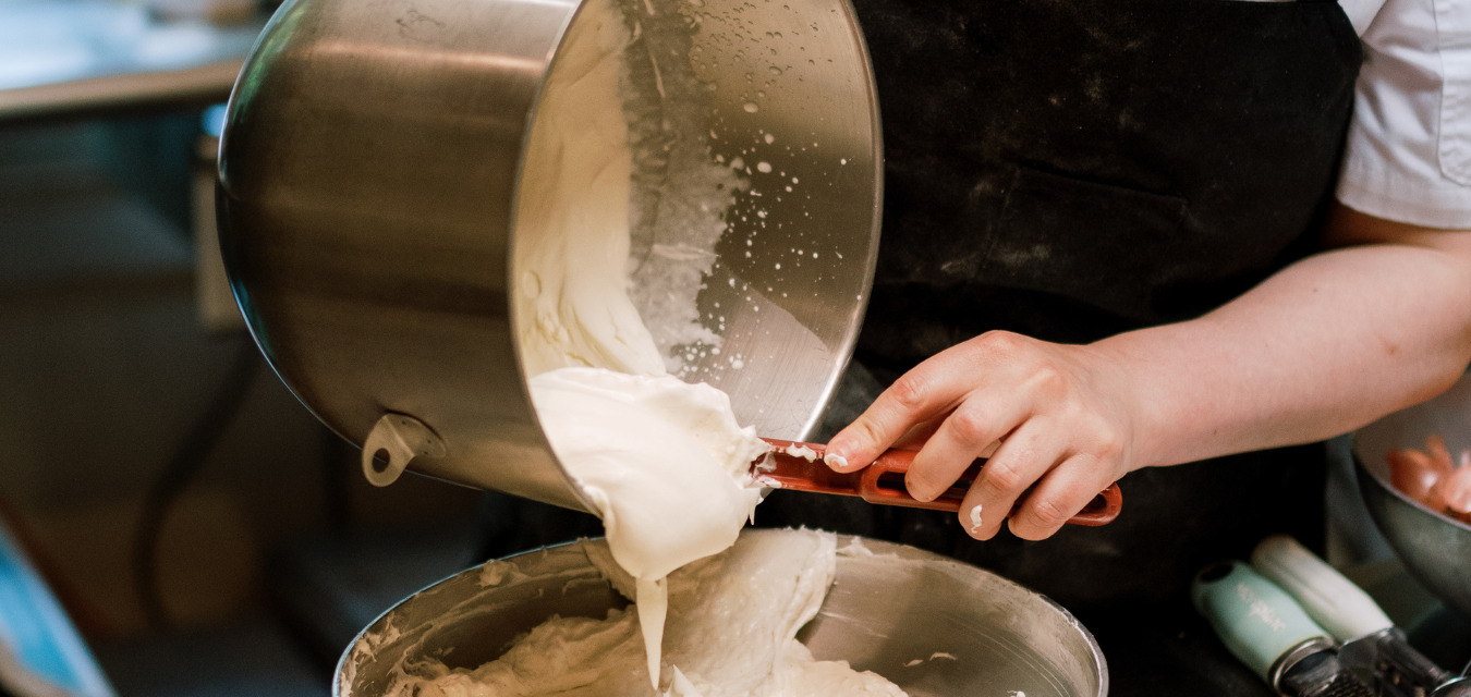 Traditional Pie Dough being poured out of a bowl with a spatula