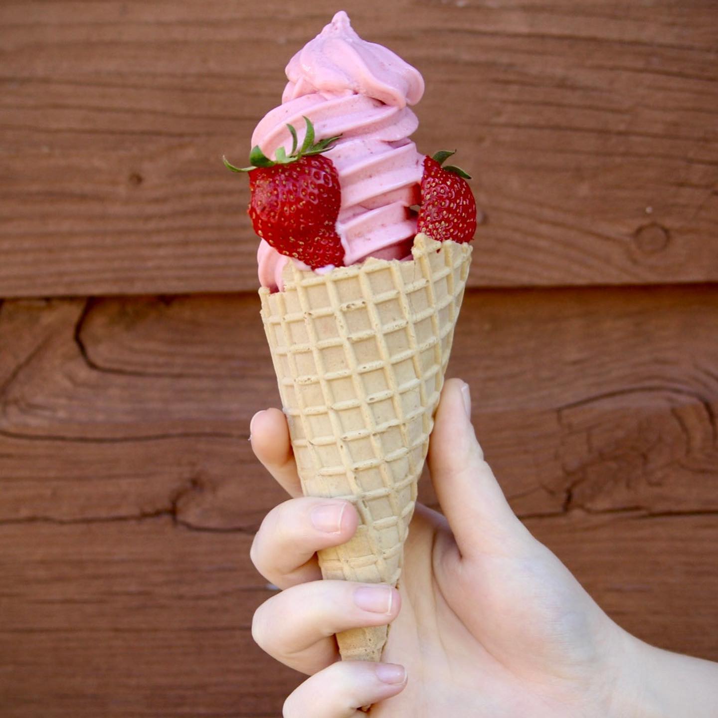 Strawberry ice cream cone with sliced strawberries incorporated, a market treat in Watsonia