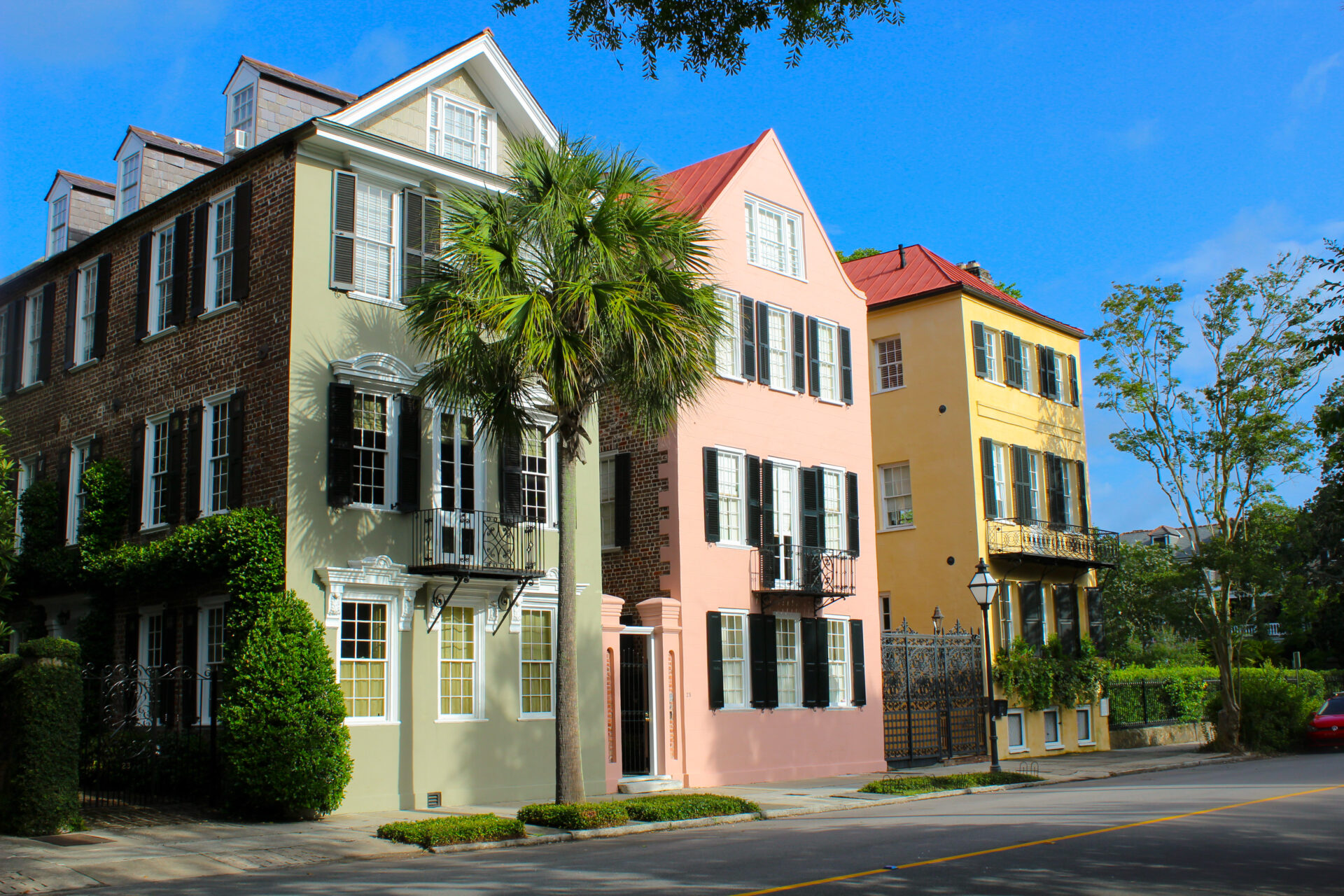 Downtown Charleston houses with yellow, pink, and green exteriors