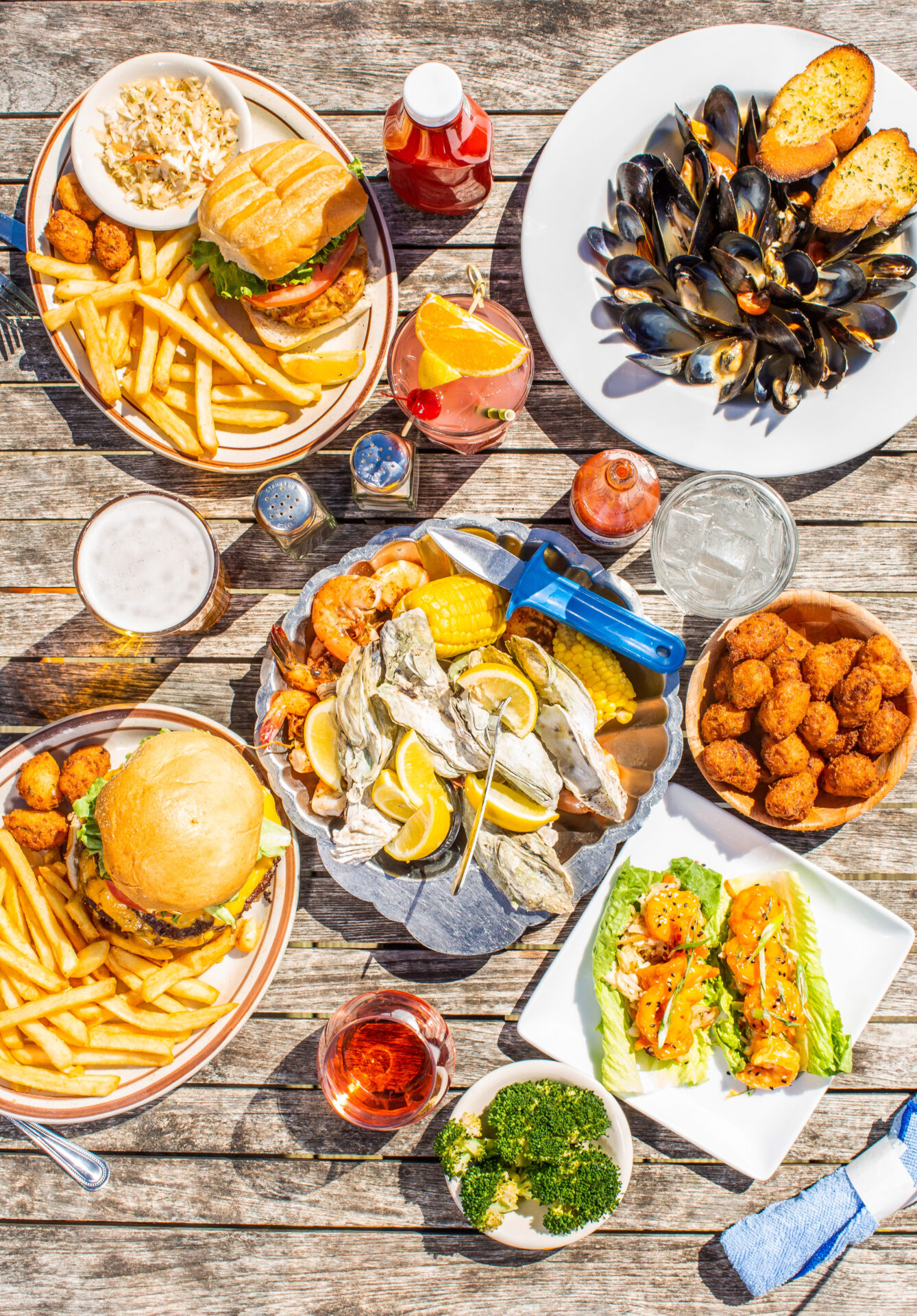 Table spread with seafood, burgers, and fries